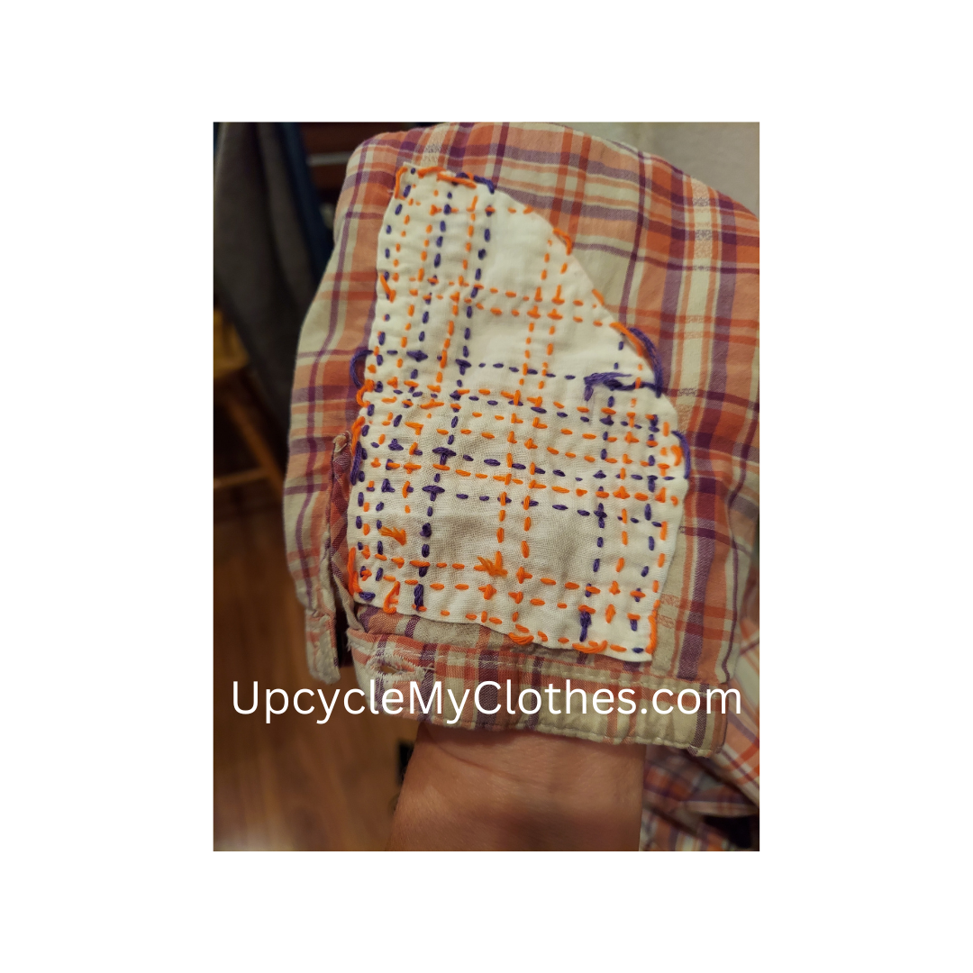 Worn elbow reinforced with fabric on the inside